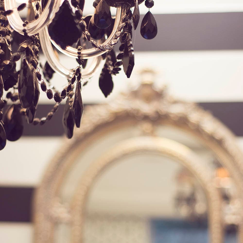 Chandelier and gilded mirror inside the salon